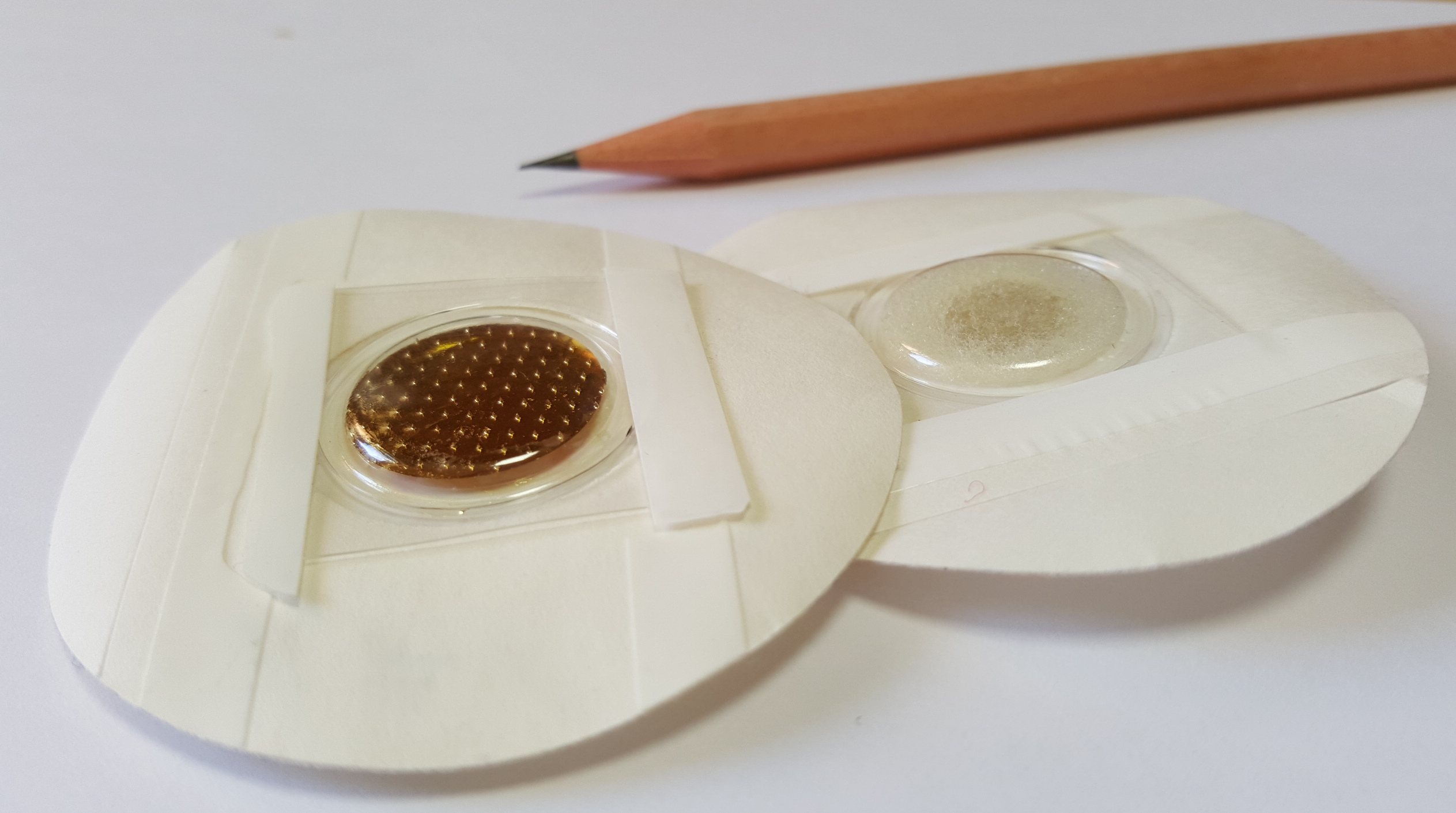 Prototype microneedle-based dry electrode (left) and conventional wet electrode (right). 